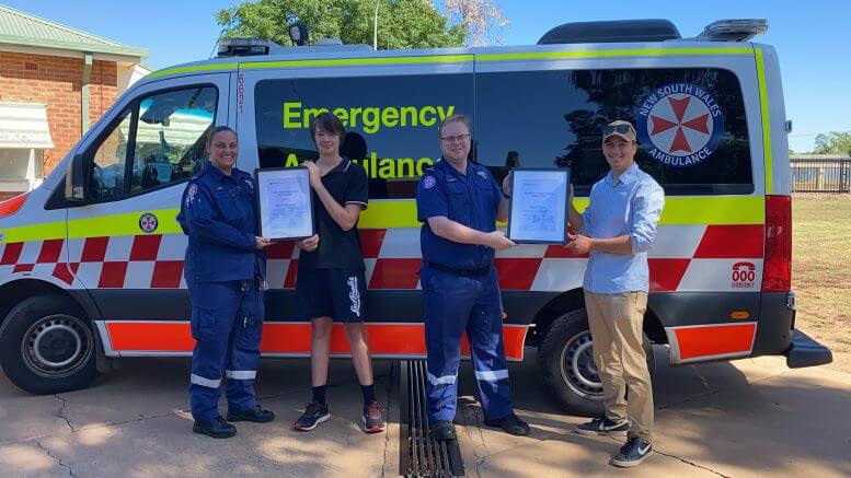 • Paramedic Kim Little, Connor Thompson, Station Officer David Truscott, and Nnoah Turner. The two local boys were presented with Certificates of Appreciation (Community) from NSW Ambulance following their bravery after a School bus crash in December 2018. Image Contributed.