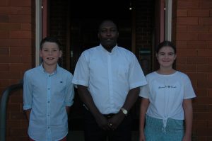 Archie Ryan St Joseph's Parish School Condobolin Captain, Father vincent Kamba and St Joseph's Parish School Condobolin Captain Molly Ticehurst.