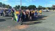 Tullibigeal Central School's School Captains followed by students during the march.