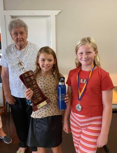 The Bruce and Beryl L’Estrange Trophy for 8 Years Champion Girl was won by Cleo Whiley. Runner Up was Winter Hall. They are both pictured with Alison Peasley. Image Credit: Condobolin Amateur Swimming Club Facebook Page.