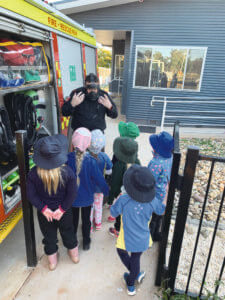 Alex showed the girls some of the equipment a firefighter may need to use, here he's showing them a gas mask.