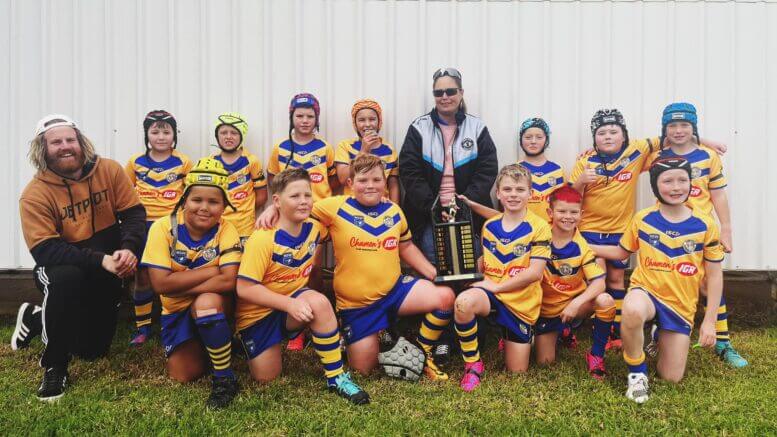 ABOVE: Condobolin Under 10s Gold Junior Rugby League team with their coach Scott Elliott and Malcolm’s sister Sonia Buerckner. Image Credit: Scott Elliot Facebook Page.