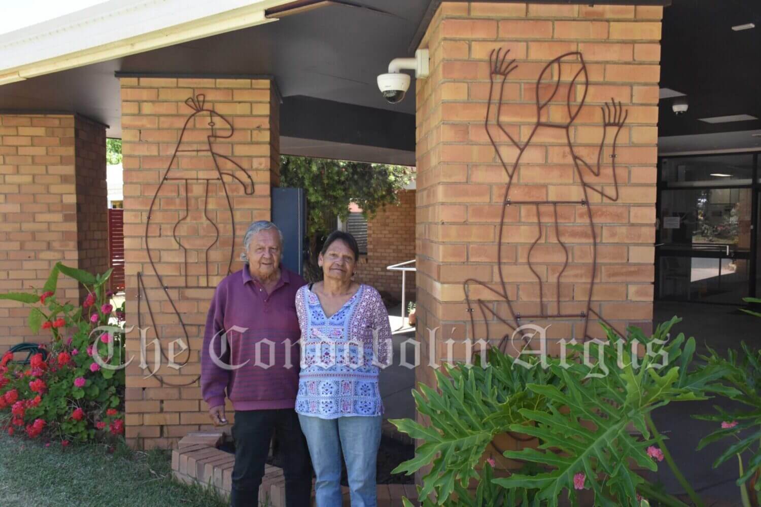 Wiradjuri Artist Bev Coe and Paul Escreet with Wiradjuri Totems, which are part of the new art and signage at the Condobolin Health Service. Bev imagined the overall design, while Paul Escreet helped in the manufacturing of the totems. Image Credit: Melissa Blewitt.